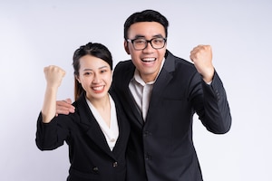 Asian businessman and businesswoman posing on white background