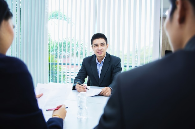 Asian businessman discussing documents and ideas at meeting