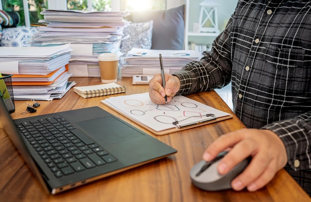 Asian businessman online working at home with a lot of document at home. Busy and exhausted.