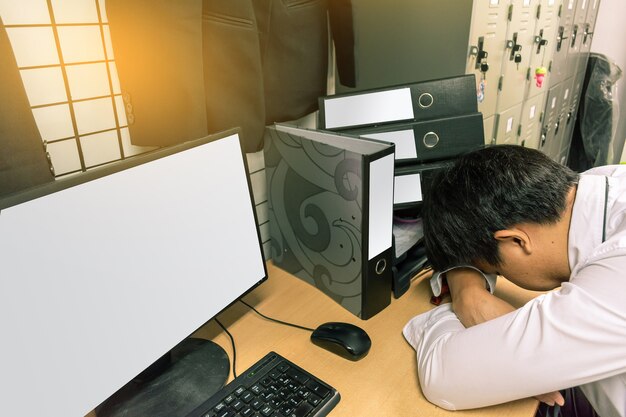 Asian businessman Sleep in office while working computer.