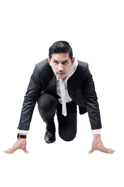 Asian businessman in start position ready to run