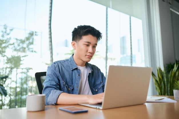 Asian businessman typing laptop keyboard