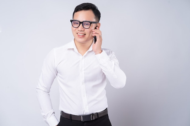 Asian businessman using smartphone on white