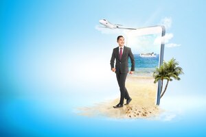 Asian businessman walking on the beach