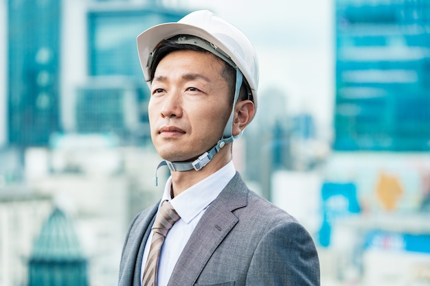 Asian businessman wearing a helmet