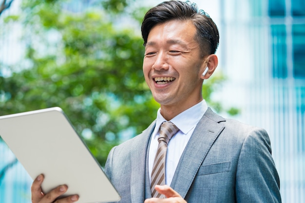 Asian businessman who communicates online using a tablet PC