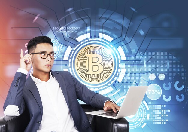 Photo asian businessman with a laptop bitcoin