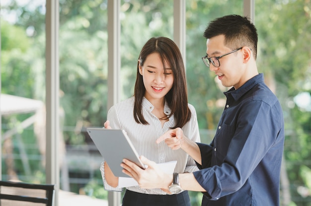 Asian businessman and woman discussing new business project