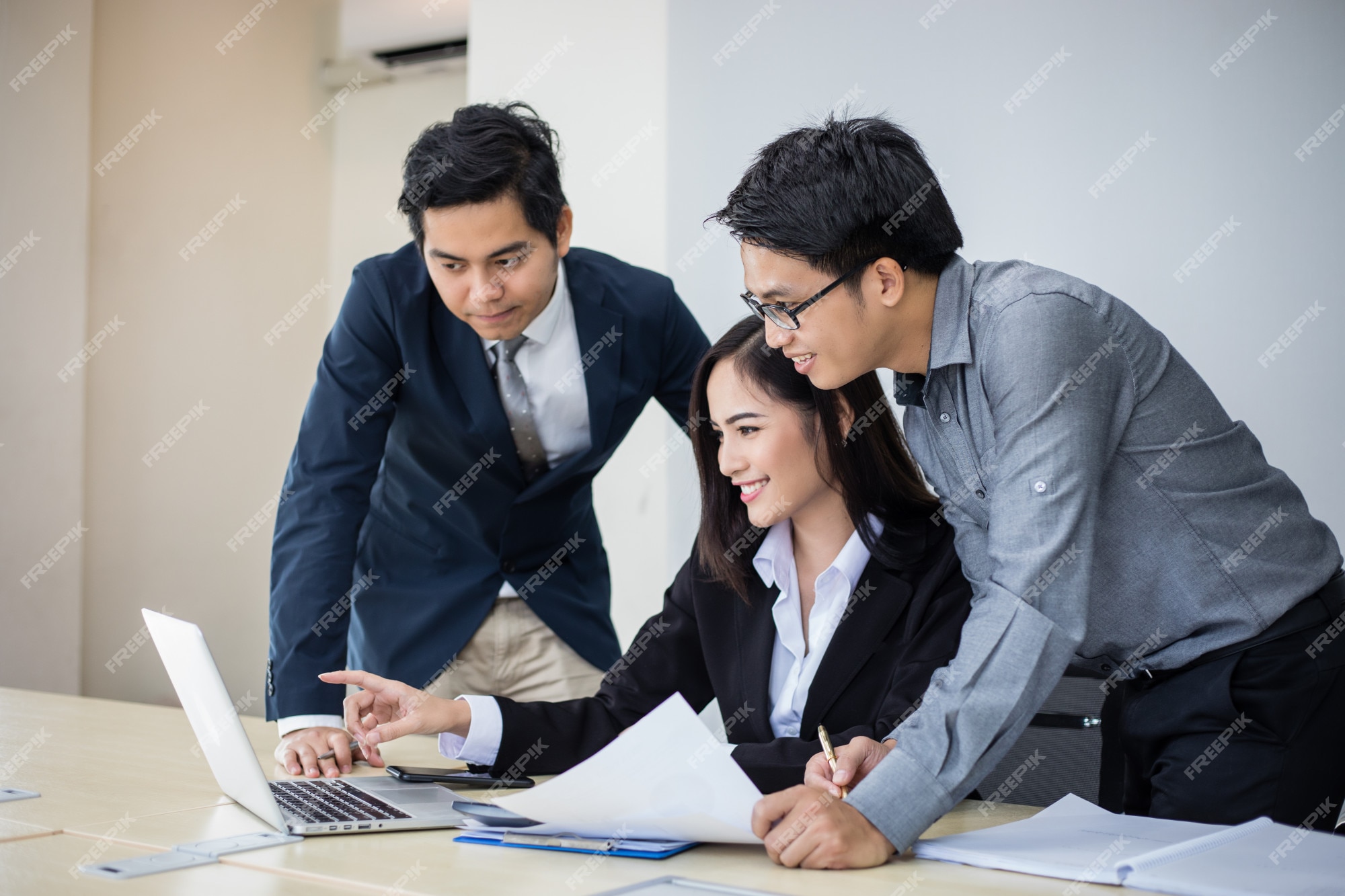 Premium Photo | Asian businessmen and group using notebook for business partners discussing documents and ideas at meeting and business women smiling happy for working