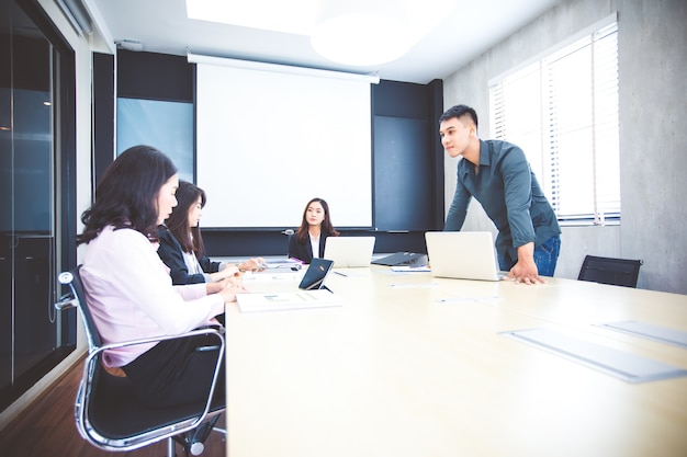 Asian businessmen and group using notebook for meeting serious about the work 