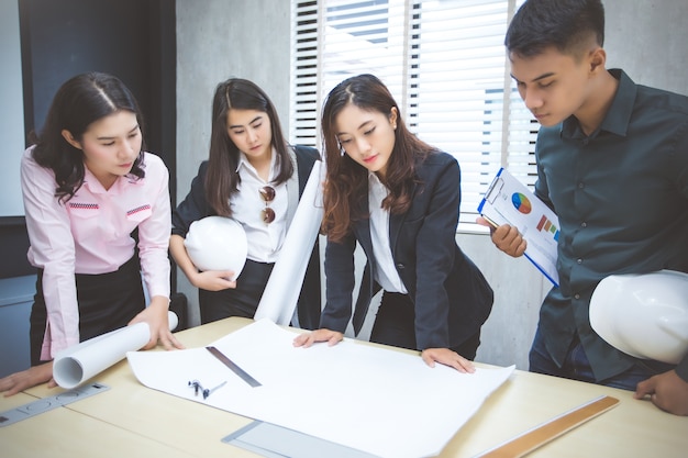 Asian businessmen and group using notebook for meeting 