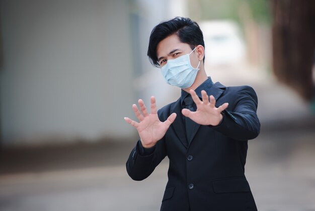 Asian businessmen look good, are sick, and wear masks. The rapid spread of the new Coronavirus by birth in Wuhan, China.