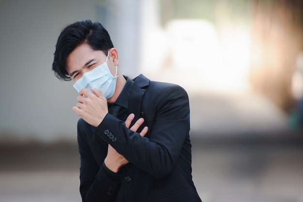 Asian businessmen look good, are sick, and wear masks. the rapid spread of the new coronavirus by birth in wuhan, china.