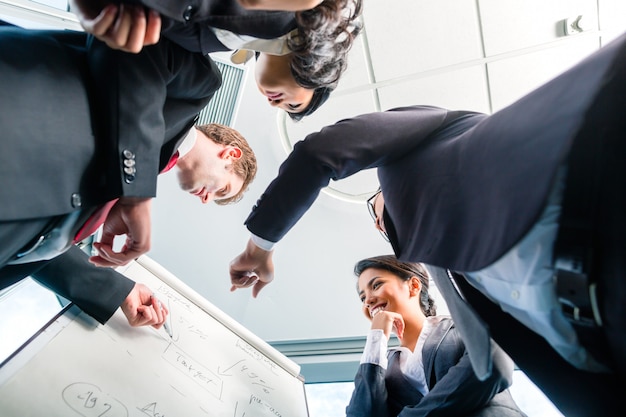 Asian Businesspeople looking at flipchart