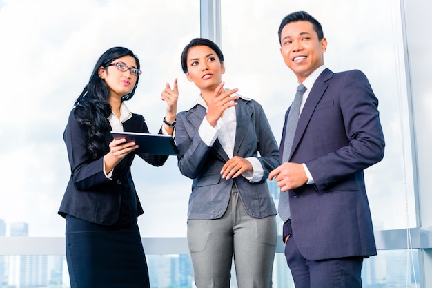 Asian Businesspeople standing in office