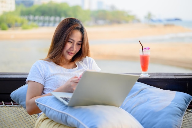 Asian businesswoman chating on smartphone with customer. Freelancer using technology for work everywhere.