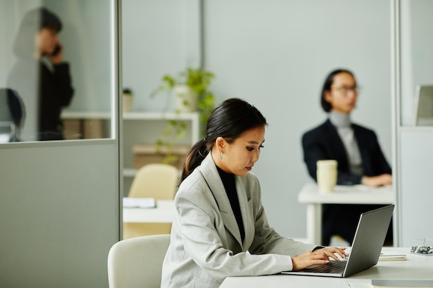 Asian Businesswoman in Cubicle