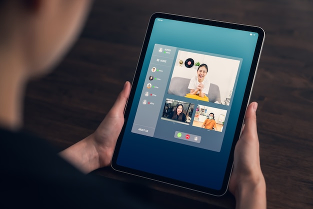 オンラインでチームを組んで作業プロジェクトを提示するためにビデオ通話会議を行うアジアの実業家。