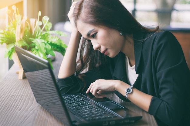 Asian businesswoman serious about the work done until the headache,soft focus