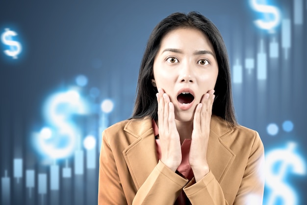 Asian businesswoman shocked looking dollar virtual bar chart with digital background