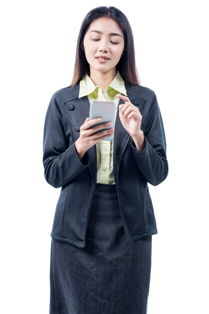 Asian businesswoman standing while using mobile phone