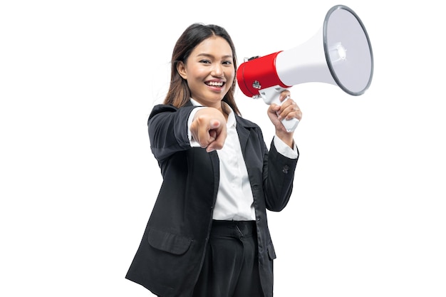 Asian businesswoman talking on a megaphone and pointing to the camera