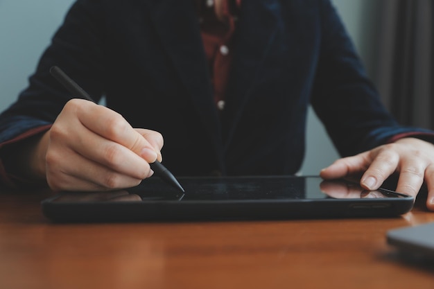 Asian Businesswoman Using laptop computer and working at office with calculator document on desk doing planning analyzing the financial report business plan investment finance analysis concept