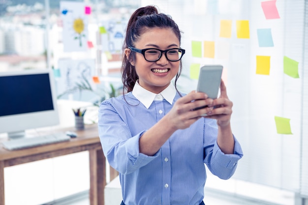 Asian businesswoman using smartphone in office