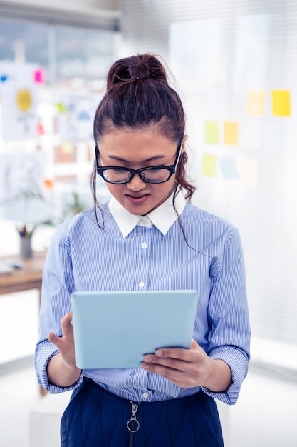 Asian businesswoman using tablet in office