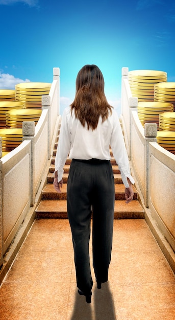 Asian businesswoman walking on the bridge with coins