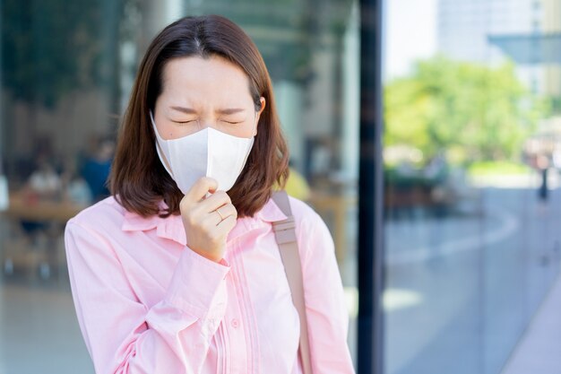 asian businesswoman wear mask to protect dust and COVID-19  virus while walking outdoor