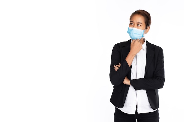 Photo asian businesswoman wearing surgical face mask in black suit jacket poses like thinking