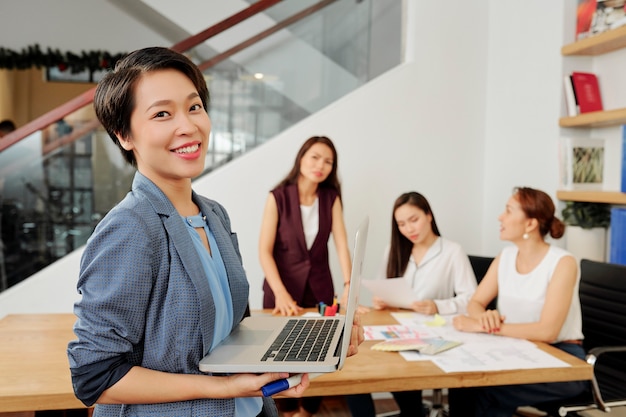 Asian businesswoman with opened laptop