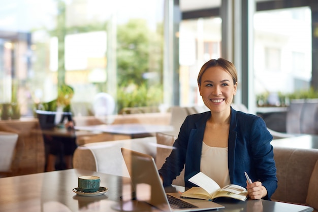 Asian Businesswoman Working at Cafe