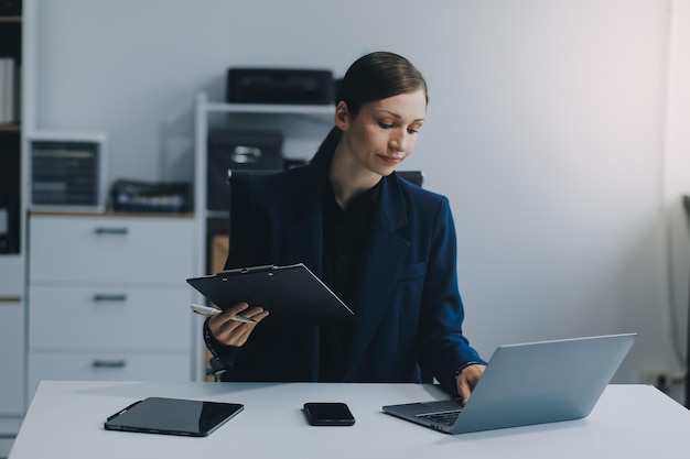 Asian businesswoman working with digital finance marketing chart at office Accounting statistics concept