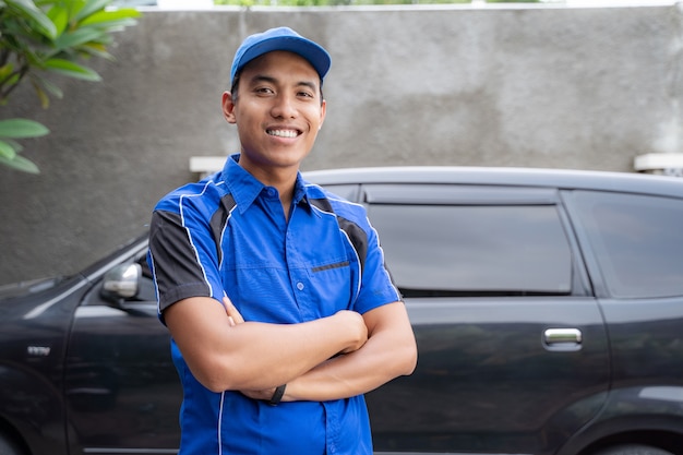 Asian car mechanic smiling to camera