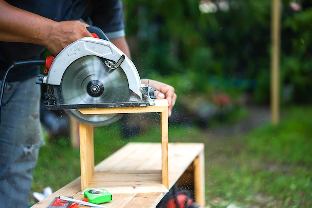 Asian carpenter are sawing the wood