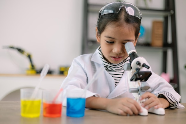 Asian child girl learning science chemistry with test tube making experiment at school laboratory education science chemistry and childrens concepts Early development of children