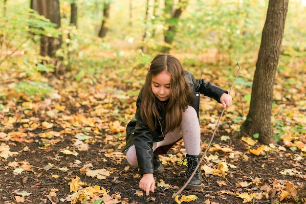 Asian child girl playing in autumn on nature childhood and season concept