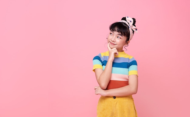 Asian child girl thinking something isolated on pink wall.