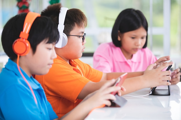 Asian child playing tablet computer together