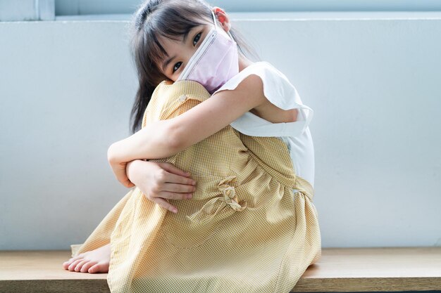 Asian child wearing mask at home