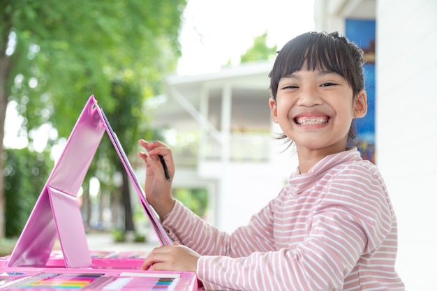 Asian Children learn to draw in the classroom.