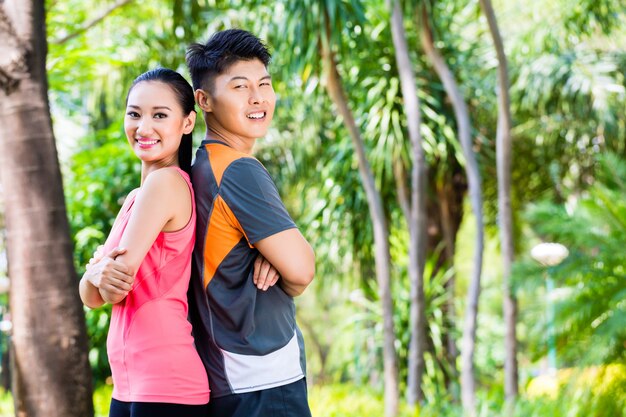 Asian Chinese couple finish running training in park