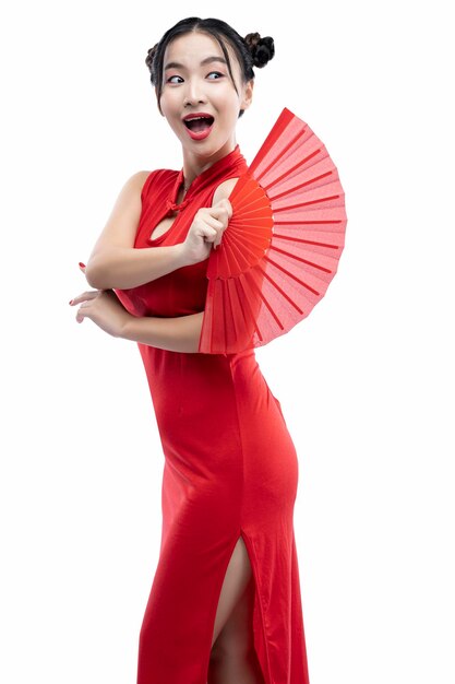 Asian Chinese woman in a cheongsam dress holding a red Chinese fan