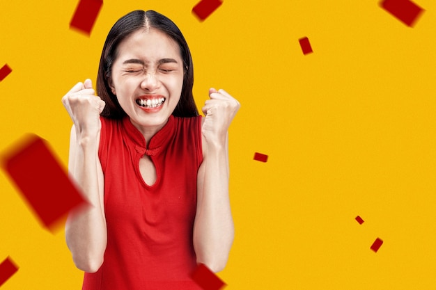 Asian chinese woman in a cheongsam dress with happy expression celebrates chinese new year. happy chinese new year