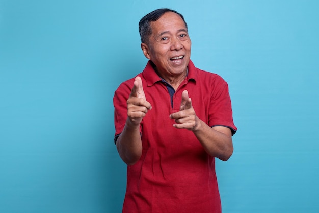 Asian confident elderly man pointing finger at camera and smiling