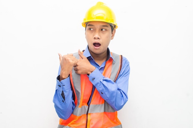 Asian construction worker pointing, presenting and promoting something goods.