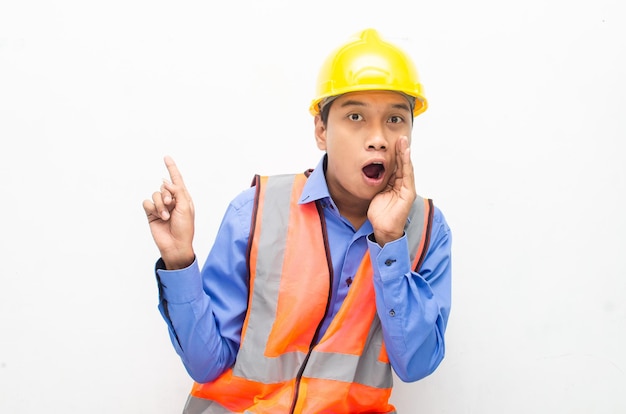 Asian construction worker pointing, presenting and promoting something goods.