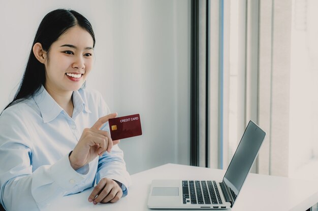 asian consumer woman holding credit card ready to spending pay online shopping according to product